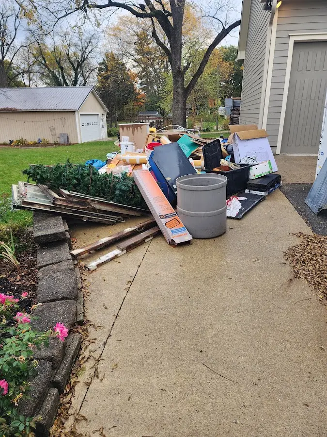 Dumpster being loaded with debris for Roofing Dumpster Rental in Niskayuna
